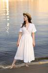 Біла лляна сукня на запах зі спідницею-полусонце та рукавами-крильцями